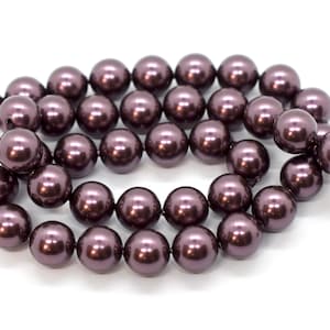 May include: A strand of dark purple faux pearl beads. The beads are round and have a smooth, glossy finish.