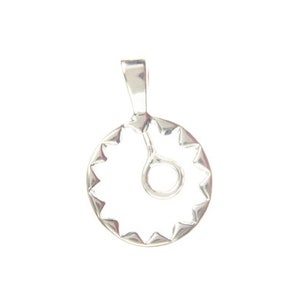 May include: Silver pendant featuring a circular design with a starburst border and a stylized sun symbol in the center.