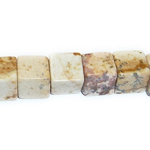 May include: A strand of light brown and white square-shaped gemstone beads. The beads have a mottled pattern and are approximately 1 cm in size.