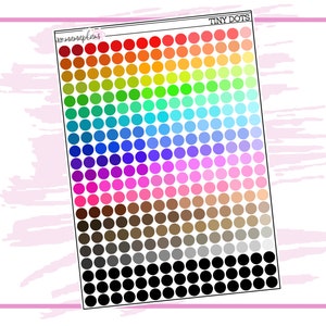 May include: A sheet of colorful tiny dot stickers. The dots are arranged in a rainbow pattern, with black dots at the bottom.