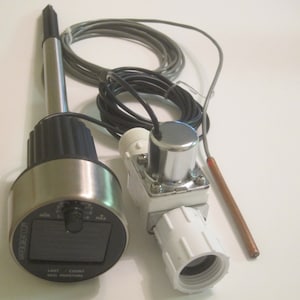 May include: A soil moisture sensor with a stainless steel probe and a black and silver dial. The dial reads "WATER COUNT SOIL MOISTURE". A white plastic component and copper-colored probe are also visible.