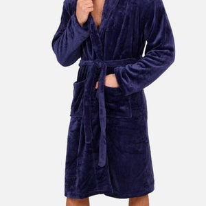 May include: A dark blue plush robe with a shawl collar and a tie belt.