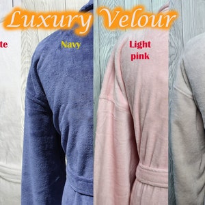 May include: Four plush robes in different colors: white, navy blue, light pink, and light gray. The robes are made of velour and have a shawl collar and a tie belt. The text "Luxury Velour" is printed on the top of the image.