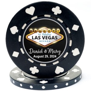 May include: Black casino chip with a white border and a design featuring a welcome to Las Vegas sign with the text "To Fabulous Las Vegas, Nevada". The chip also has the text "Daniel & Mary, August 29, 2024".