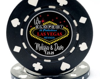 May include: Black casino chip with a white border and a design that says "We Eloped! In Fabulous Las Vegas Nevada" with the names Melissa & Dave and the date 7.23.25.