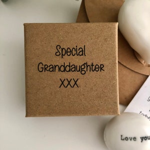 May include: A small brown box with the text "Special Granddaughter XXX" printed on the top.