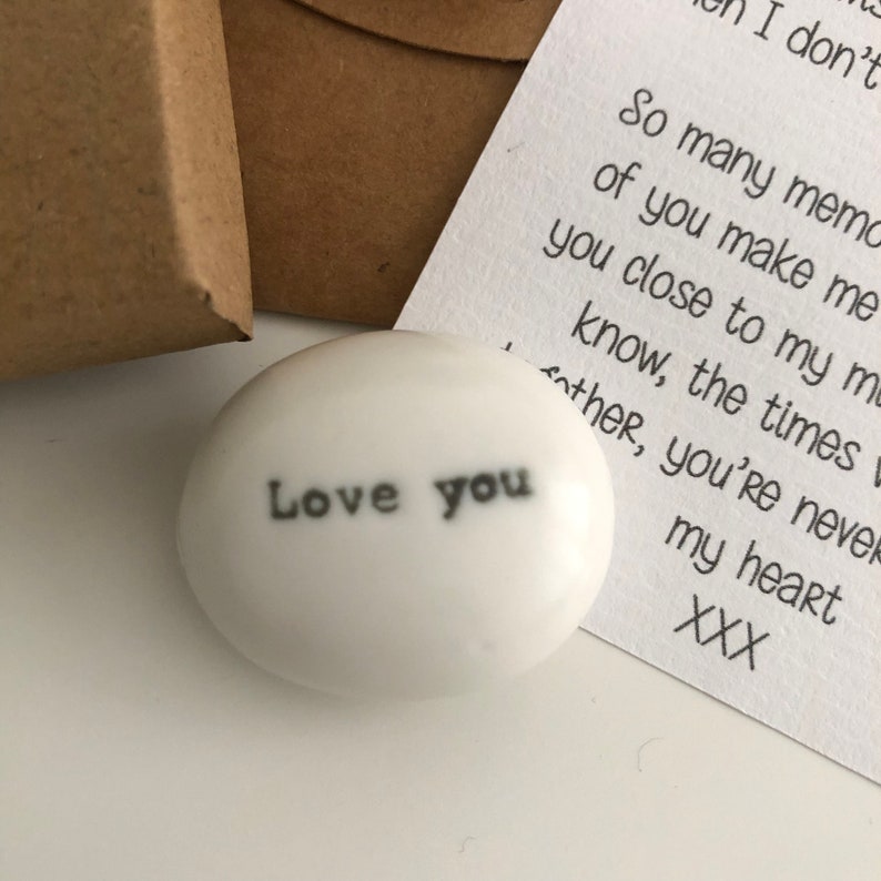 May include: White ceramic stone with the words "Love you" written in black.