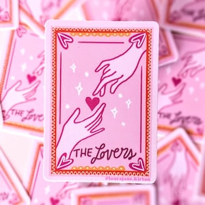 May include: Pink sticker featuring a tarot card design with two hands reaching for a heart. The card is framed with a red border and the words "THE Lovers" are written at the bottom. The background is filled with similar stickers.
