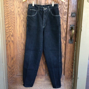 May include: A pair of dark wash high-waisted jeans with a button fly and belt loops.