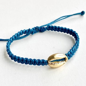 May include: A set of three ceramic nesting bowls in shades of blue, green, and white. The bowls feature a speckled glaze and a simple, modern design. The largest bowl measures approximately 6 inches in diameter.