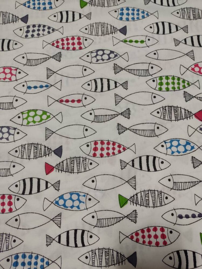 May include: White fabric with a repeating pattern of black outlined fish with various colored polka dots, stripes, and solid colors.