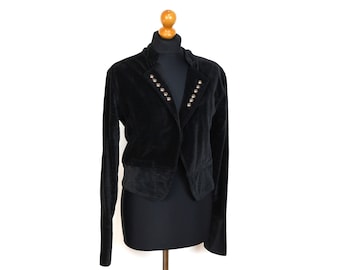 May include: A black velvet blazer with gold-toned button accents. The blazer has a cropped length and a classic lapel collar.