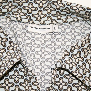 May include: A blue and white patterned shirt with a collar. The shirt has a label that says "TOM TAILOR" and "L" for size.