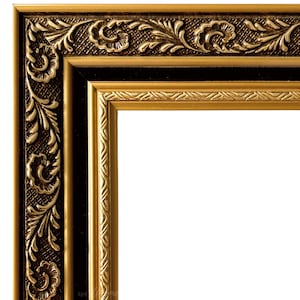May include: A gold picture frame with a black inner border and ornate detailing. The frame has a decorative, floral design.