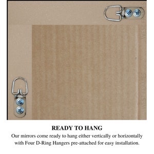 May include: Back of a framed mirror with four pre-attached D-ring hangers for easy vertical or horizontal hanging. The frame is a neutral color, and the text "READY TO HANG" is visible.