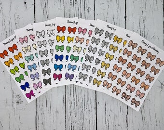 May include: A set of 10 sheets of colorful bow stickers. Each sheet has 24 bows in a variety of colors, including red, orange, yellow, green, blue, purple, pink, and gray. The bows are all the same size and shape, and they have a glossy finish.
