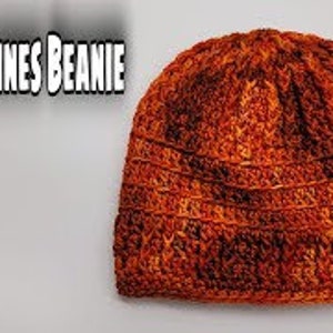 May include: A crocheted beanie in orange, brown, and red colour gradients. The beanie has a textured stitch pattern.