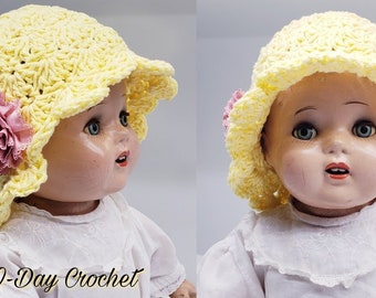 May include: A yellow crocheted sun hat with a pink flower accent. The hat is worn by a doll with a white dress. The text "Bag-O-Day Crochet" is visible at the bottom of the image.