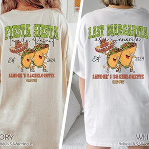 Puede incluir: Dos camisetas blancas con un gráfico de dos tacos de dibujos animados que llevan sombreros y sostienen un vaso de margarita. El texto en las camisetas dice "Fiesta Siesta Tequila Repeat Est. 2024 Sander's Bachelorette Cancun" y "Last Margarita as a Senorita Est. 2024 Sander's Bachelorette Cancun".