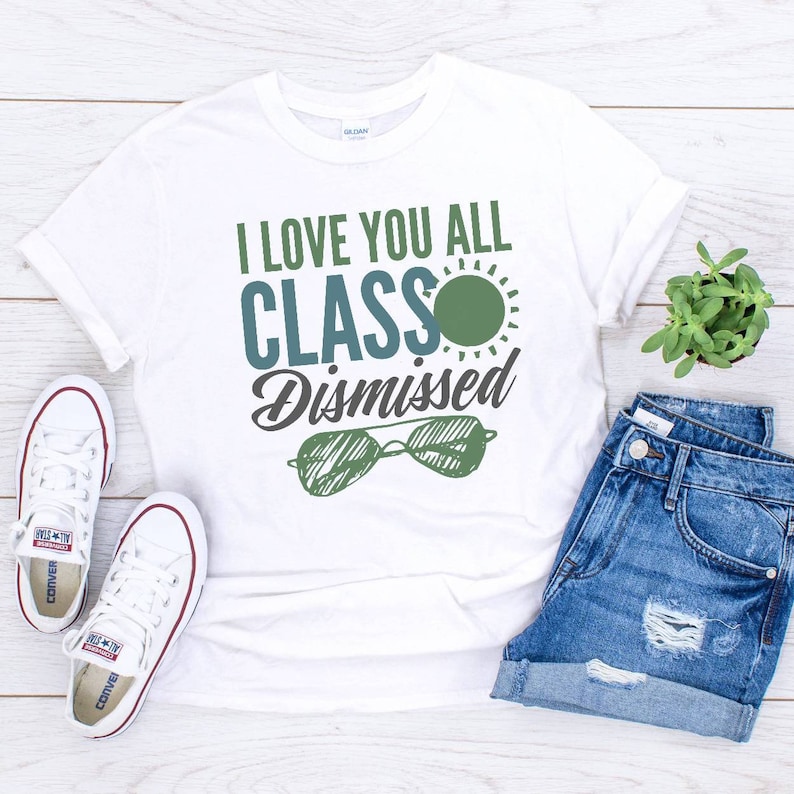 May include: White t-shirt with the text "I love you all class dismissed" in blue and green lettering. A green sun with a blue outline is above the word "class". A pair of sunglasses with a green frame and blue lenses are below the text.