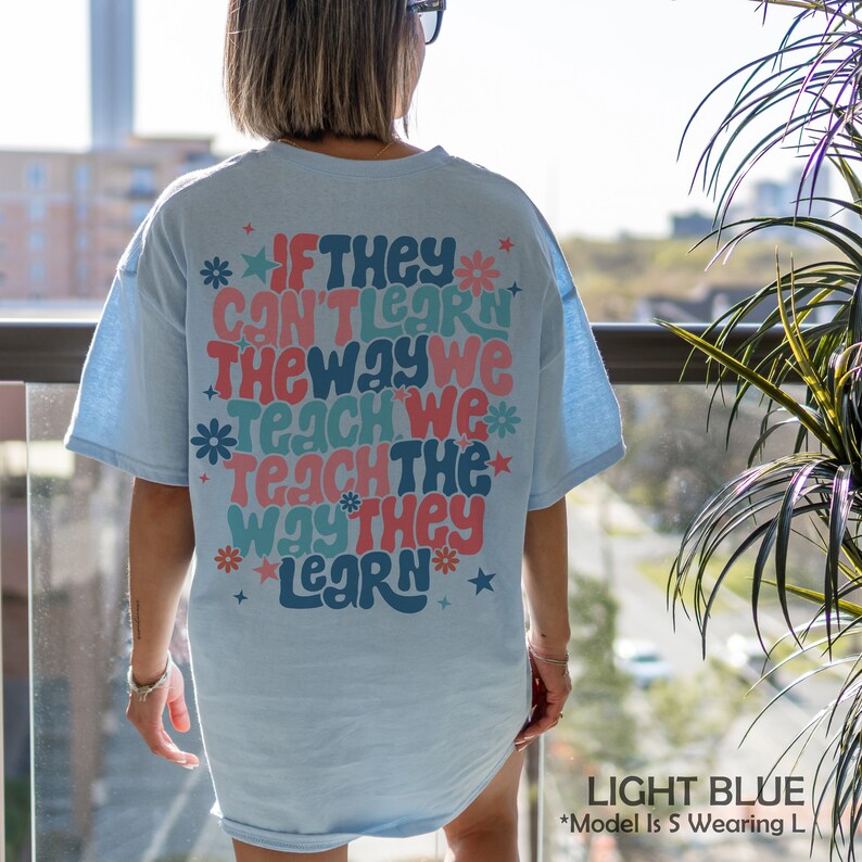 May include: Light blue t-shirt with a retro-style graphic that reads "If they can't learn the way we teach, we teach the way they learn".