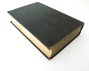May include: A dark green hardback book with a worn, aged appearance. The book has a gold-coloured spine and edges.