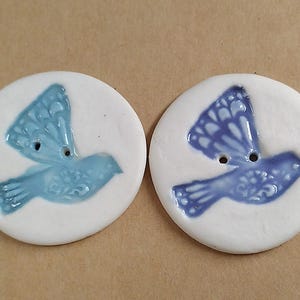 Two porcelain dove buttons
