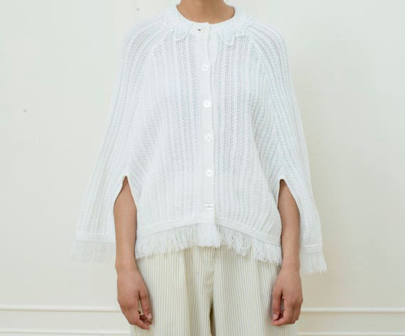 white poncho sweater