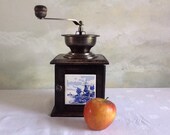 Vintage french coffee grinder. Coffee grinder with blue and white ceramic tiles. Coffee grinder with windmill decoration.