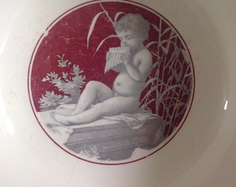 Rare antique Digoin Sarreguemines bowl. Digoin bowl with cherub. Serving bowl with flute playing cherub on grey, red and cream faience.