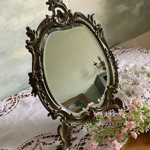 Brass vintage French mirror with beveled mirror glass in excellent condition. Decorative self standing mirror.