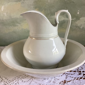Antique wash basin and pitcher set. Vintage white porcelain wash bowl and jug.