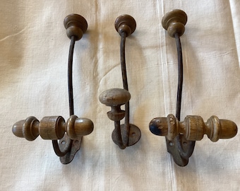 Antique French cast iron and wood coat hooks. Hooks from an old French school. Large coat hooks. Set of 3 hooks.