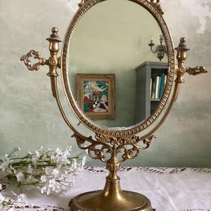 Large vintage French pivotal oval brass mirror. Tabletop mirror Height 50 cms. Width 35 cms ( 19.75 x 14 ins.). Gold Rococo style mirror.