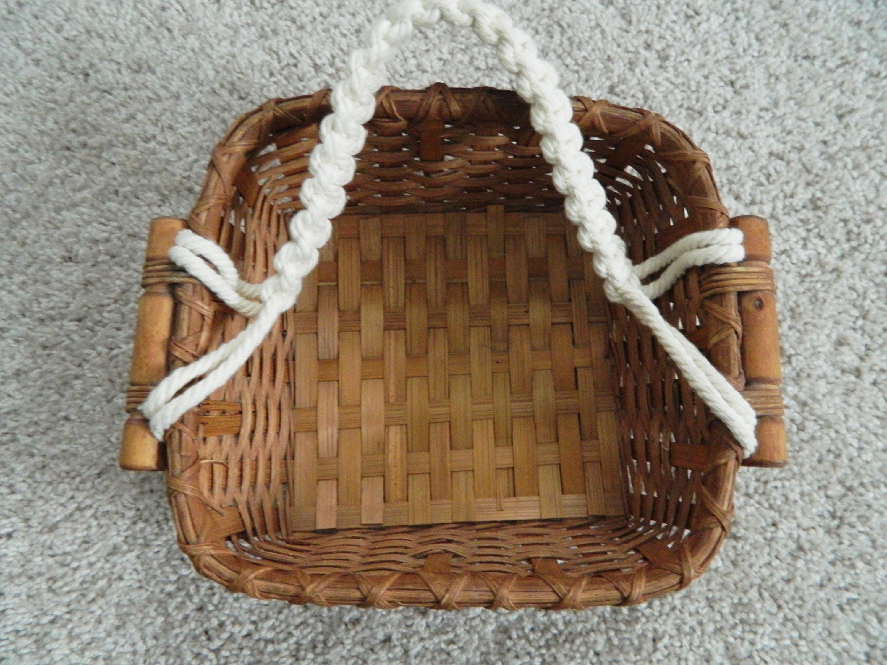 Image of Woven basket hanging from wooden dowel