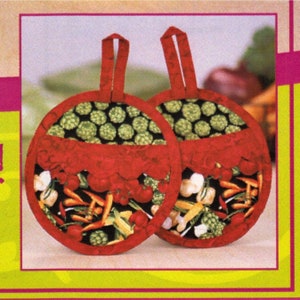 May include: A pair of red and green pot holders with a vegetable print. The pot holders have a loop handle and are made of fabric.
