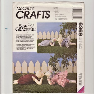 May include: Sew Graceful pattern for two piglet dolls. The pattern includes instructions for making two 19-inch tall piglet dolls with clothes. The dolls are pictured in a pink and blue dress and overalls.