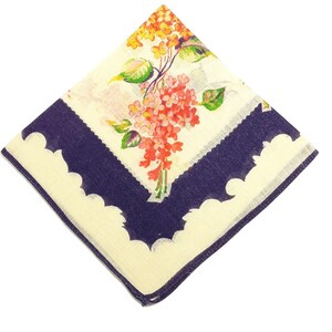 May include: Square handkerchief with a floral design. The center features a bouquet of red and yellow flowers with green leaves. The border is navy blue with a scalloped edge, and the background is off-white.
