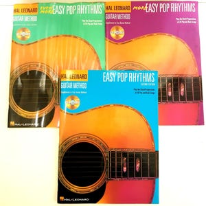 May include: Three guitar method books with a CD included. The books are titled "Easy Pop Rhythms" and feature a guitar on the cover. The first book is green, the second is orange, and the third is purple.
