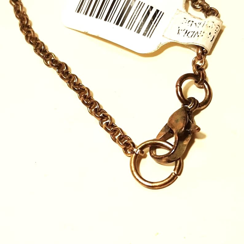 May include: A gold chain necklace with a lobster clasp closure.