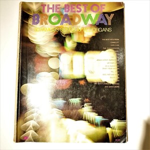 May include: The Best of Broadway: 50 Famous Songs for All Organs book cover featuring a colorful abstract design with a list of songs including Camelot, Can-Can, The Fantasticks, and more.