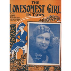 May include: Vintage sheet music cover for "The Lonesomest Girl in Town". It features a portrait of Dorothy Taylor and an illustration of a woman in a blue dress and hat. The background is orange with decorative floral elements.