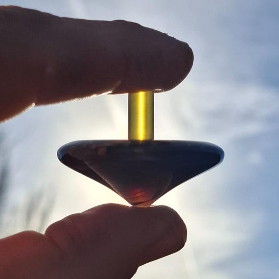 A hand-turned EDC spinning top made from exotic Juma Dragonscale resin and Ultem — the kind of pocket object that starts conversations and never leaves your jacket.