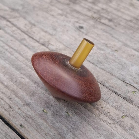 A lathe-turned precision spinning top machined from vintage 1970s micarta with an Ultem stem — this is a genuine EDC craftsperson's piece, not a toy.