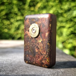 Collector's Edition edc worry stone in WW2 Rag Micarta | Spent casing inlay | 1970s paper micarta back. Unique & rare pocket art