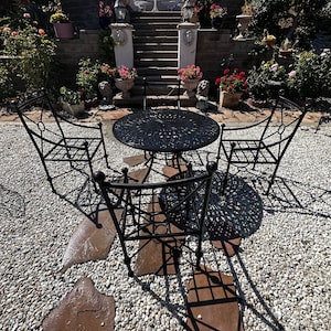 Patio set by Woodard, Land grave collection, 46” Diameter, all metal,table is cast aluminum, Wrought Ironheavy armchairs with metal bottoms