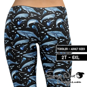 May include: Black leggings with a repeating pattern of blue whales, narwhals, jellyfish, and small fish. The text on the leggings reads "TODDLER - ADULT SIZES" and "2T - 6XL". The leggings are from Spirit West Designs.