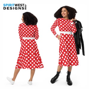 May include: A red midi dress with white polka dots and a white belt. The dress has long sleeves and a round neckline. The model is wearing the dress with black ankle boots.