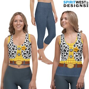 May include: A women's workout outfit featuring a yellow, red, and black tank top with a cow print vest and a denim-look pair of leggings.