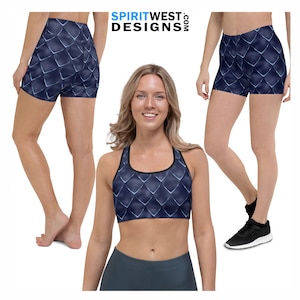 May include: A woman is wearing a navy blue sports bra and matching shorts with a scale pattern. The sports bra has a black band around the top and bottom. The shorts have a high waist and are form-fitting.